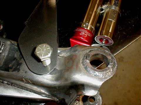1996 Ford Bronco - A detailed view of a vehicle's suspension part, showing welds and attached components.