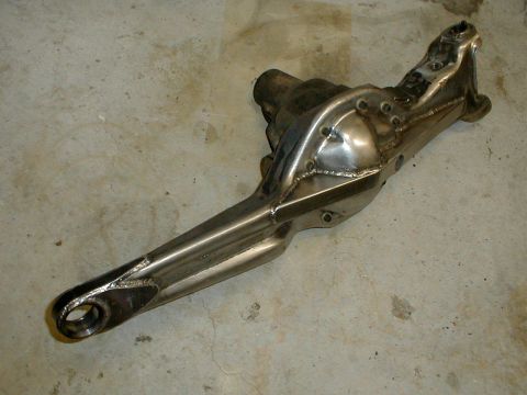 1996 Ford Bronco - Close-up view of a modified front suspension axle housing, likely for an off-road vehicle.
