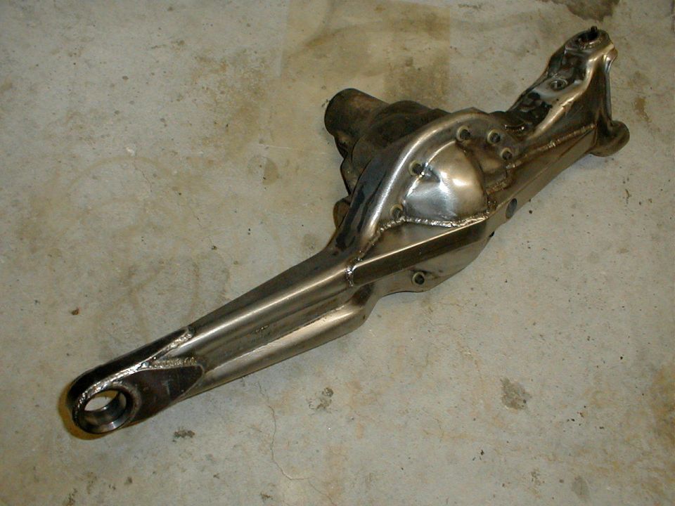 Front suspension axle housing with welded reinforcements