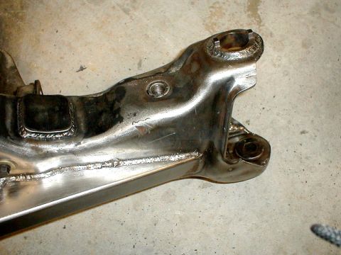 1996 Ford Bronco - A close-up view of a vehicle's suspension component, showing metal fabrication and welds.