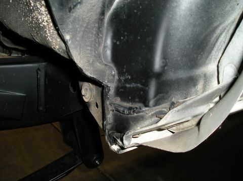 1986 Toyota Hilux - Detail shot of the underside of a vehicle, showing damage to the fender and frame area.