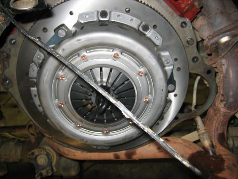 1990 Ford Bronco - Close-up view of a vehicle's clutch and flywheel assembly, showing the pressure plate and disc components.