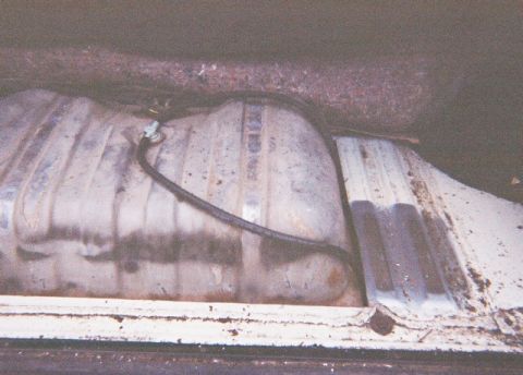 1991 Ford Bronco - Close-up view of a vehicle's fuel tank and associated lines.