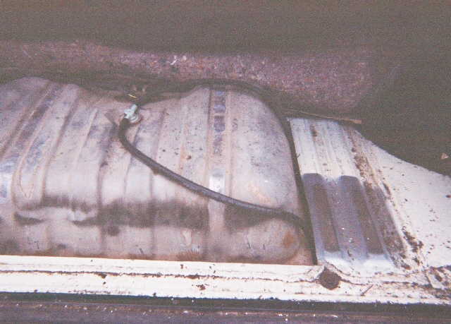 Fuel tank with lines running to it, seen from above