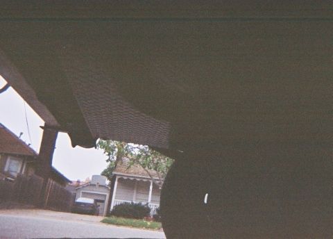 1991 Ford Bronco - View from inside a vehicle shows houses and a street with another car visible in the distance.