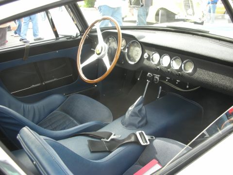 1998 Ford Crown Victoria - blue cloth interior of a vintage Ferrari showing a wood-rimmed steering wheel, gauges and floor shifter.