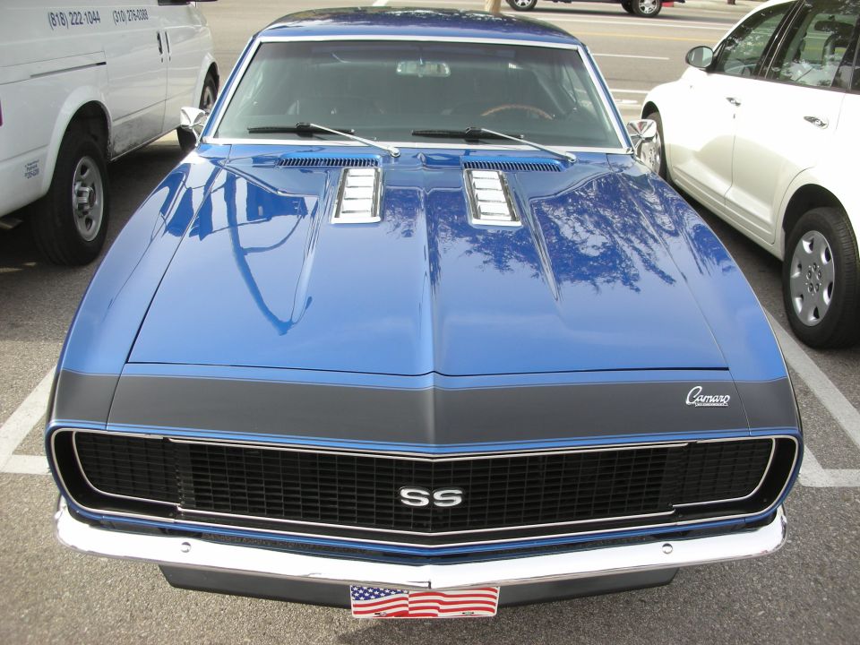 Front of a blue Chevrolet Camaro SS with black grille and hood stripe