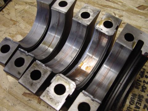 1979 Ford Bronco - Engine bearings show significant wear and scoring, indicating potential internal engine damage.
