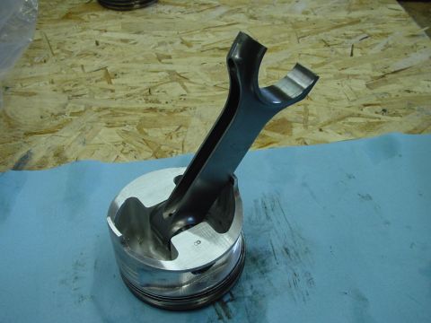 1979 Ford Bronco - A close-up view of an engine piston and connecting rod assembly, with a number 8 visible on the piston.