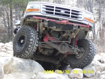 1996 Ford Bronco - This modified Ford Bronco is navigating a rocky trail, its off-road capabilities.