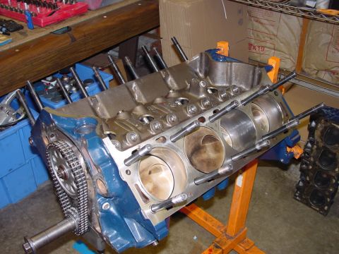 1979 Ford Bronco - Engine block assembly, likely undergoing rebuild, with pistons and timing chain exposed.