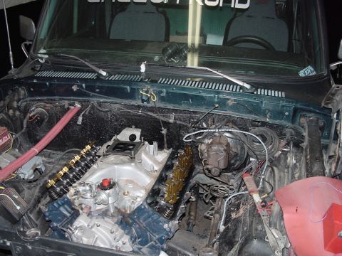 1979 Ford Bronco - The engine bay of a 1979 Ford Bronco shows the engine partially disassembled during a rebuild.