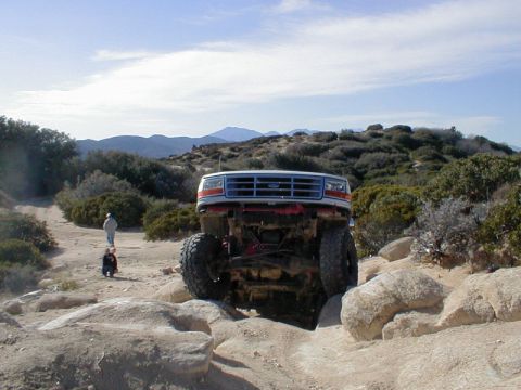 1996 Ford Bronco - This 1996 Ford Bronco is navigating a rocky obstacle on a desert trail.