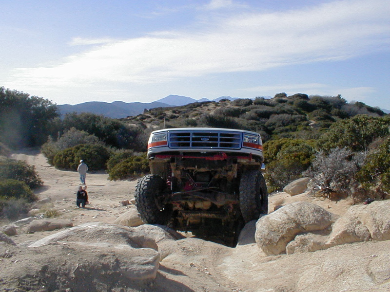 1996 Ford Bronco climbing over rocks on an off-road trail