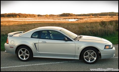 1998 Ford Taurus - Side view of a silver Ford Mustang from the late 1990s.