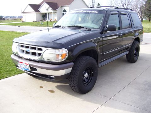 1996 Ford Explorer - This black Ford Explorer SUV is shown from a 3/4 front angle on a paved driveway.