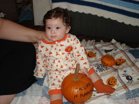 2000 Ford Crown Victoria - A baby celebrates Halloween with pumpkins and festive pajamas.
