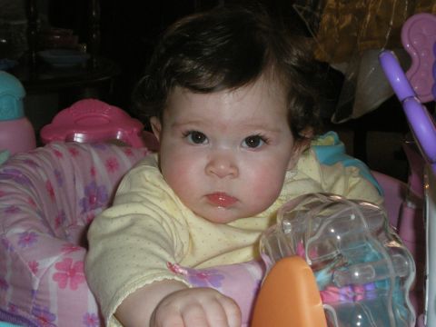 2000 Ford Crown Victoria - A baby with a serious expression looks forward from a colorful play seat.