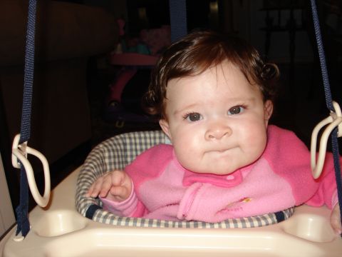 2000 Ford Crown Victoria - A baby sits in a baby jumper, looking towards the camera.