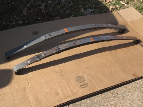 1968 Shelby GT500 - Comparison of a restored and unrestored leaf spring, laid out on cardboard.