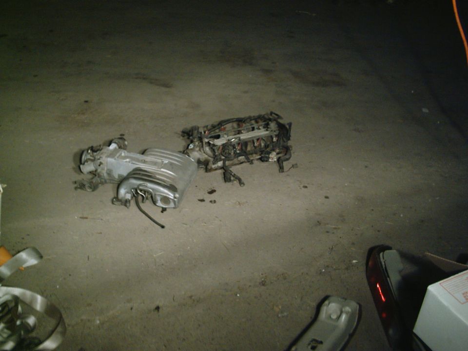 Engine intake manifold and cylinder head assembly on concrete floor