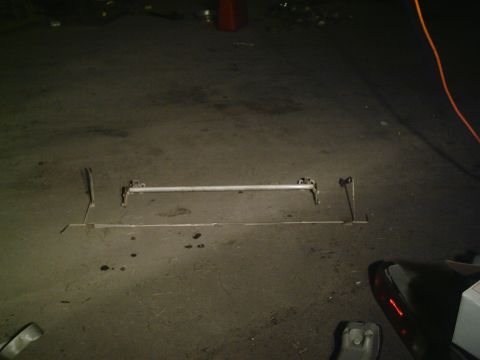 2001 Dodge 2500 - A sway bar assembly is laid out on a concrete surface, likely for installation or repair.