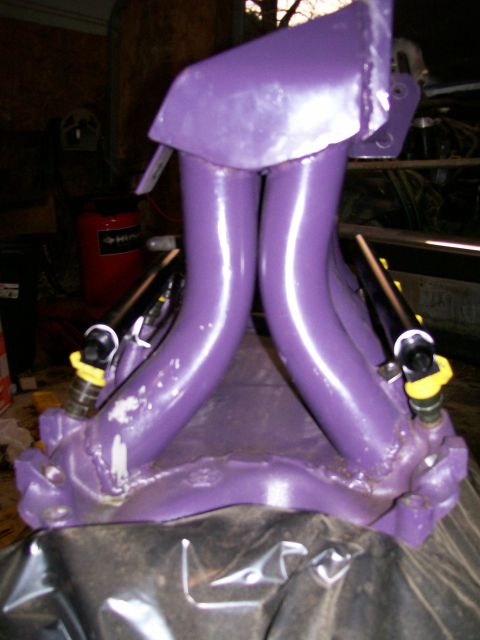 1988 Ford Bronco - A close-up of a purple intake manifold with fuel injectors, likely a custom part.