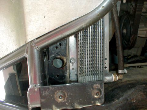 1996 Ford Bronco - A close-up view of engine components, including a radiator and a drive belt, is visible.