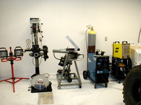 1996 Ford Bronco - A workshop scene various tools including a drill press and welding equipment.