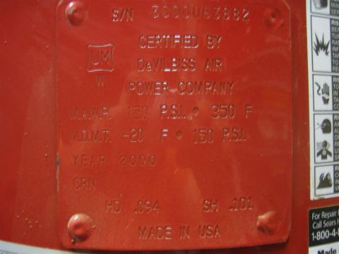 1994 Ford Bronco - This red metal plate shows embossed text including serial number, certification, and year 2000.