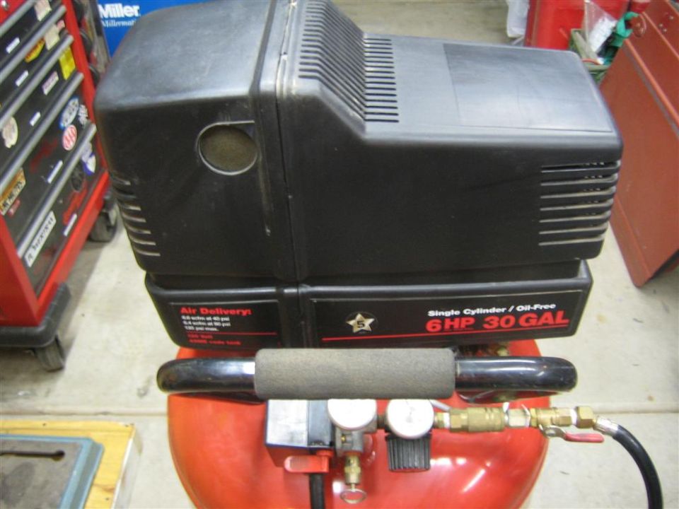 Black air compressor with red tank, 6HP 30 GAL label visible