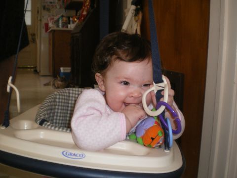 2000 Ford Crown Victoria - A baby smiles while playing in a Graco walker.