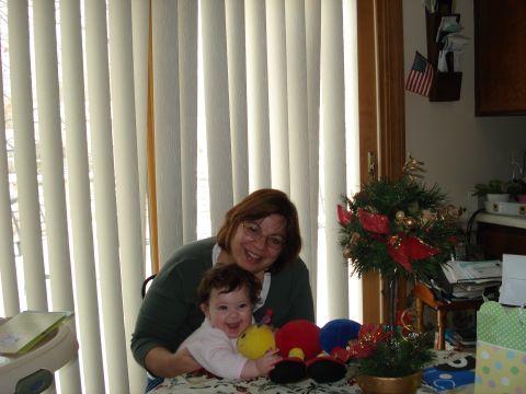 2000 Ford Crown Victoria - A woman and a baby are sitting together with toys on a table.
