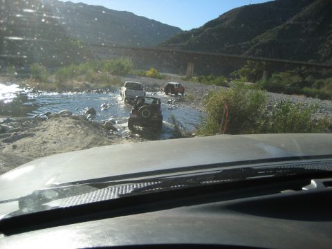 1993 Ford Bronco - Off-roading adventure through a river with multiple vehicles.