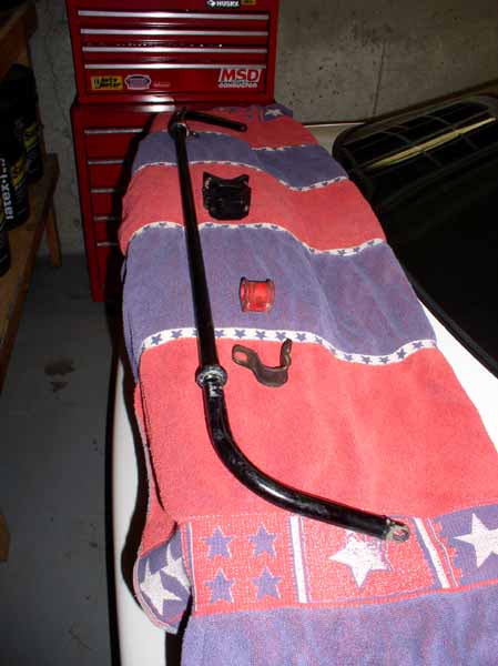 1996 Ford Probe - Anti-roll bar and associated hardware laid out on a towel in front of a red toolbox.