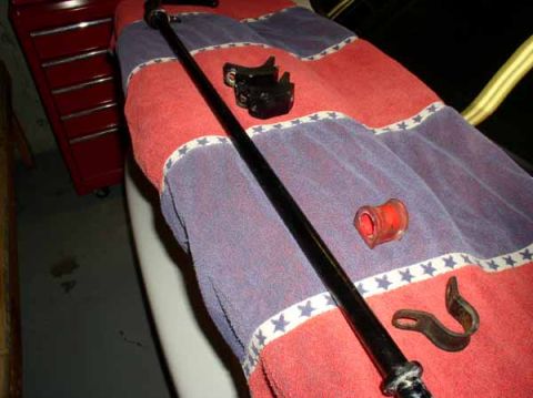 1996 Ford Probe - Sway bar and associated parts laid out on a towel next to a red toolbox.