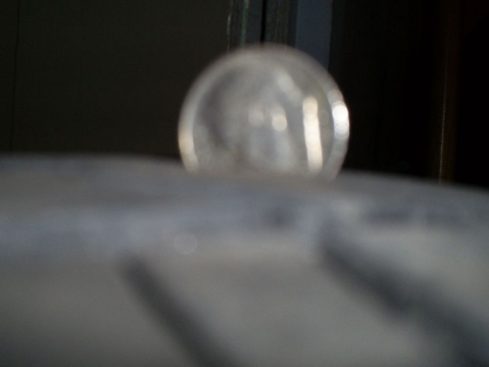 Close-up of tire tread with a clear dome light visible above it