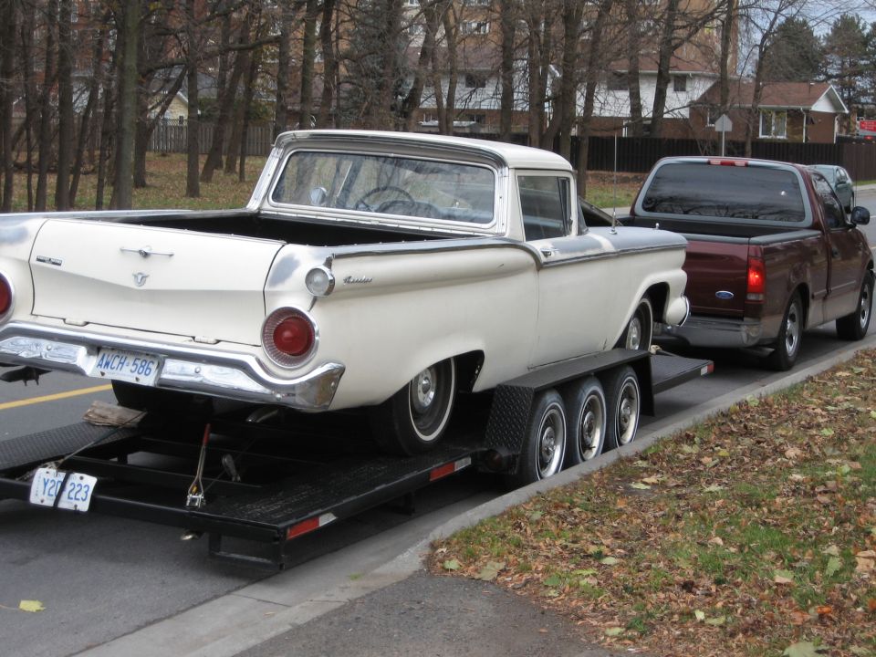 White 1959 Ford Ranchero on a trailer, rear view. License plate AWCH-586