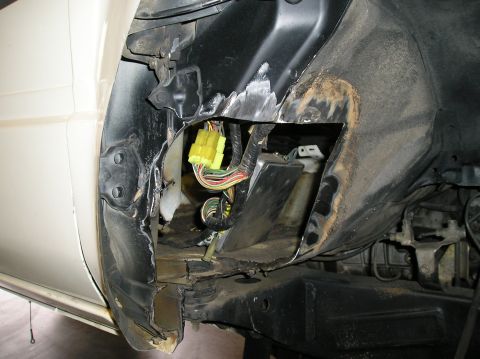 1986 Toyota Hilux - Close-up view of the firewall area on a 1986 Toyota Hilux, showing exposed wiring and a yellow electrical connector.