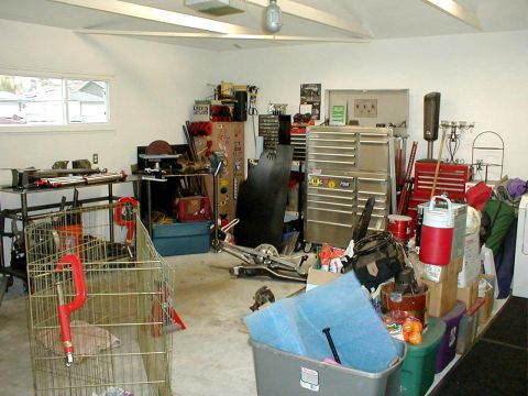 1996 Ford Bronco - A cluttered garage scene with various tools, storage, and equipment visible.
