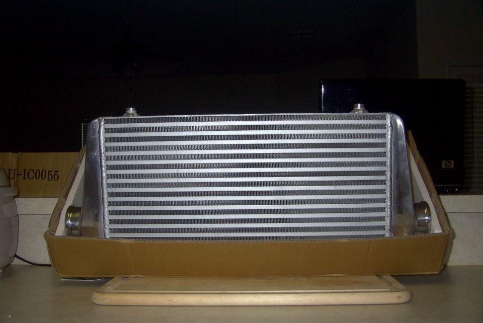 Intercooler in cardboard packaging with 'NU-IC0055' visible