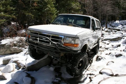 1996 Ford Bronco - White 1996 Ford Bronco tackles a challenging off-road course in the snow.