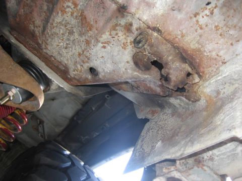 1979 Ford F-150 - Undercarriage view shows significant rust and damage to the frame components.