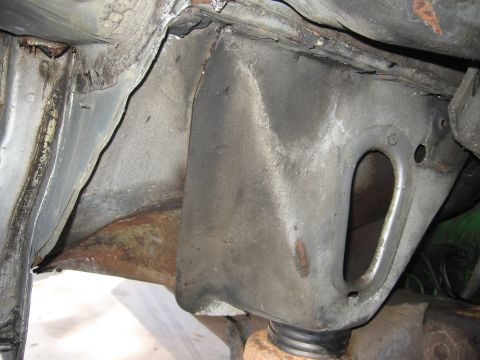 1979 Ford F-150 - Close-up view of the underbody frame and floorboard structure, showing metal components and some rust.