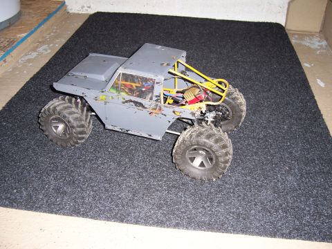 1996 Ford Bronco - This remote-controlled rock crawler features a gray body, a yellow roll cage, and oversized tires for off-road performance.