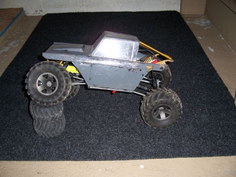 1996 Ford Bronco - This is a remote-controlled rock crawling vehicle with a gray body and large off-road tires.
