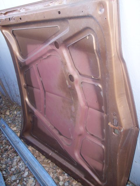 1972 Ford Ranchero - Underside of a car hood, showing structural bracing and some rust damage.