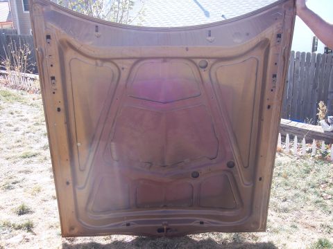 1972 Ford Ranchero - Underside of a car hood, showing structural bracing and attachment points.
