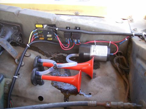 1979 Ford F-100 - Aftermarket air horn system installed, dual red trumpets and a compressor unit.