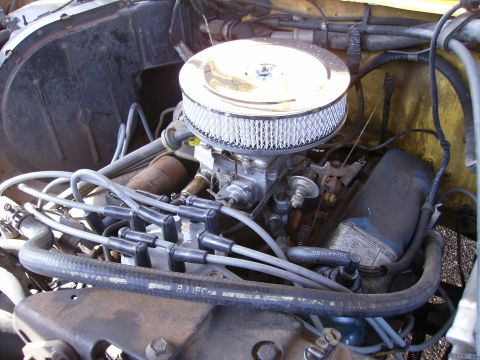 1979 Ford F-100 - Close-up of an engine bay, focusing on the carburetor and air cleaner assembly.
